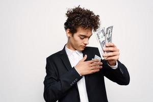 man in a suit a bundle of money in the hands of a businessman self-confidence photo