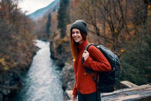 woman hiker with backpack in the forest in nature mountains river photo