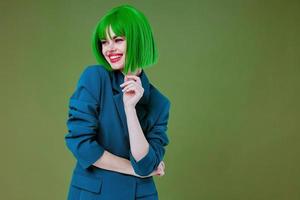 Beautiful fashionable girl wearing a green wig blue jacket posing studio model unaltered photo