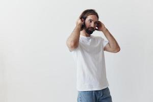 happy man listening to music and smiling in a white t-shirt on a white background happy photo