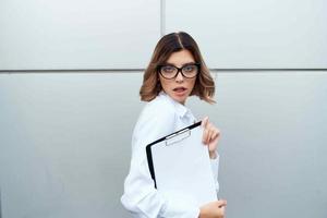 cheerful woman in white shirt documents office official businesswoman photo