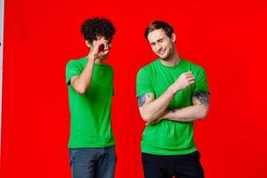 two men in green t-shirts laugh communication joy photo