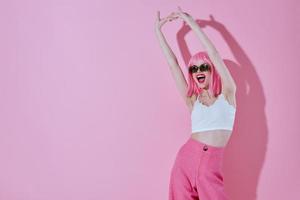 Positive young woman in a white T-shirt and pink pants glamor studio model unaltered photo