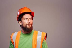 Man in working uniform orange paint safety work cropped view photo