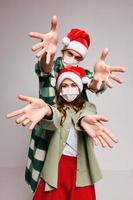Cheerful medical masked Christmas hats holiday fun New Year photo