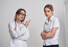 professional doctor with a stethoscope explaining something to a patient in a t-shirt photo