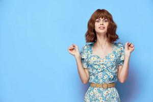 Woman in flower dress emotions hands in front of you grimace short hair photo