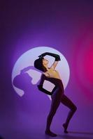 Portrait of a charming lady posing on stage spotlight silhouette disco color background unaltered photo