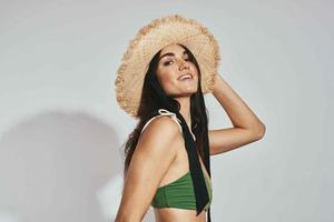 woman in green swimsuit beach hat luxury posing fashion photo