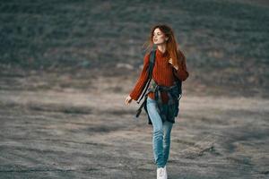 woman hiker with backpack travel mountains fresh air landscape photo