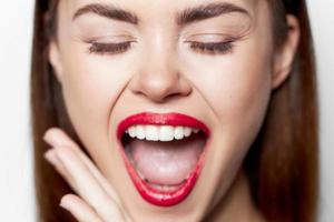 woman face close-up red bites her lip photo