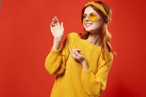 cheerful woman in yellow glasses hipster fashion posing lifestyle photo