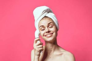 woman with towel on head cleaning skin therapy cosmetics technology photo