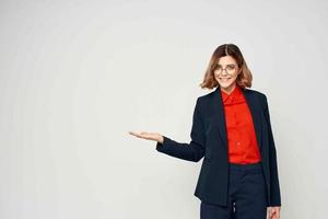 cheerful business woman in a suit gesturing with her hands work manager light background photo