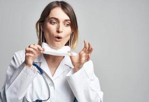 happy woman doctor in medical mask with stethoscope on neck photo