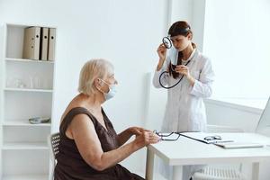 nurse in white coat stethoscope in hand health care photo