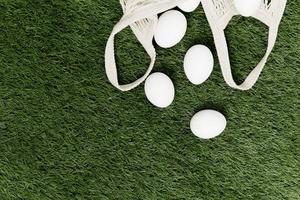 white eggs on a green lawn holiday christian day green background photo