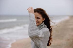 woman cloudy weather by the sea travel fresh air Relaxation concept photo