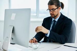 office worker work in front of a computer documents Chief photo