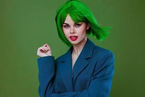 Beautiful fashionable girl attractive look green wig blue jacket posing color background unaltered photo