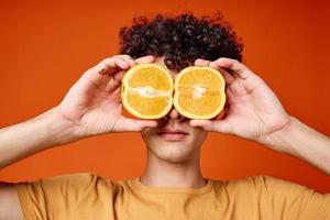 Cheerful guy with curly orange hair near the eyes close-up Studio photo