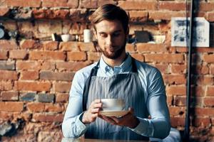 male waiter apron coffee cup Professional barista work photo