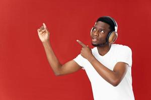 African American in headphones technology music lover red background photo