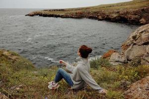 pretty woman nature rocks coast landscape Ocean Relaxation concept photo