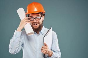 Cropped view of cheerful bearded man in orange paint in glasses with documents in hands photo