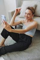 Woman blogger selfies on phone, selfies and online conversations for followers, teenager develops social media, freelancer from home photo