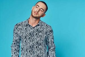 fashionable man with short hair in shirt studio blue background photo