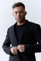 Modelling snapshots. Serious self-confident attractive handsome man in classic suit wear jacket posing isolated in white studio background. Fashion offer. Copy space for ad photo