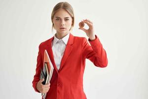 financier in a red jacket with documents in hand light background photo