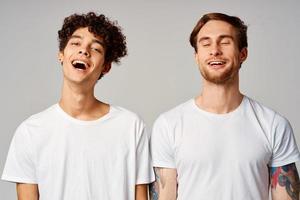 two friends in white t-shirts fun emotions isolated background photo