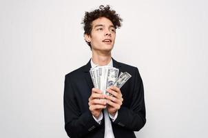 Cheerful man in a suit with money in the hands of a finance official photo