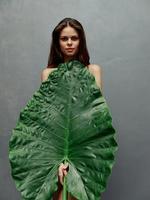 beautiful woman charming look big green leaf cover naked body photo