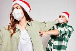 married couple wearing medical masks christmas friendship communication studio close up photo