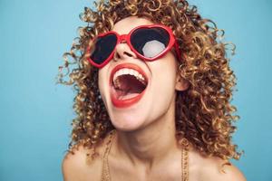 Portrait of a woman Curly hair fun close-up red heart glasses bright makeup photo