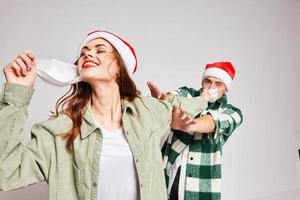 man and woman wearing medical masks Christmas New Year Studio celebration photo