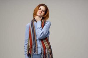 red-haired woman neck scarf cold handkerchief light background photo