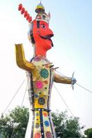 Delhi, India - January 16 2023 - Ravnans being ignited during Dussera festival at ramleela ground in Delhi, India, Big statue of Ravana to get fire during the Fair of Dussera to celebrate the victory photo