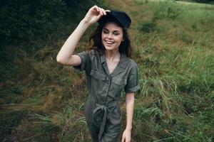 Woman in the forest cheerful woman in green jumpsuit black cap smile outdoor recreation photo