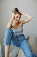 Woman photographer shooting in studio on old film camera at home on couch portrait, white background, free copy space, freelance photographer photo