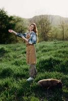 Portrait of a young girl on a summer day in the rays of the setting sun with a beautiful smile, dressed as a farmer and gardener photo