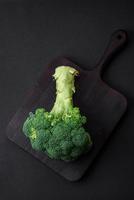 Raw fresh broccoli on a black home kitchen table photo
