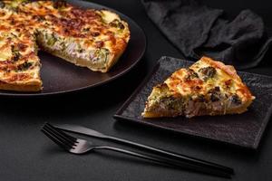 Delicious quiche with broccoli, cheese, chicken, spices and herbs photo