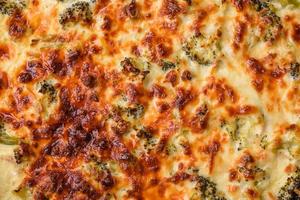 Delicious quiche with broccoli, cheese, chicken, spices and herbs photo