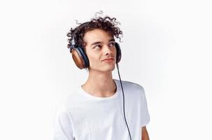 Cheerful guy with curly hair in headphones music lifestyle photo