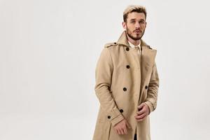 man with fashionable hairstyle in beige coat attractive look autumn style photo