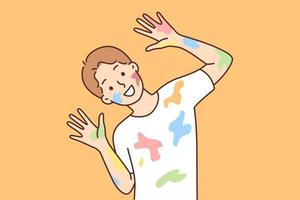 Happy boy with traces of paint on clothes and face after drawing lesson at school. Cheerful schoolboy in white t-shirt smeared with multi-colored paint looks at camera vector